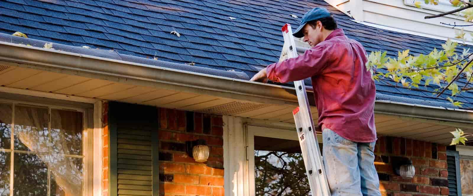 Man cleaning gutters.